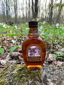 maple syrup in front of trilliums